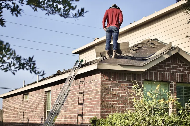 Professional roofer working on a residential roof in People's Freeway